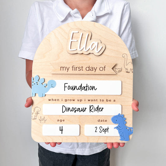 Wooden plaque with dinosaur-themed text held by a person