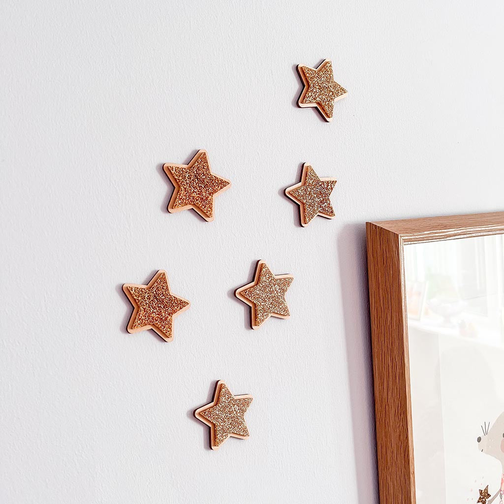 Set of four gold glitter star wall decorations with natural wooden edges