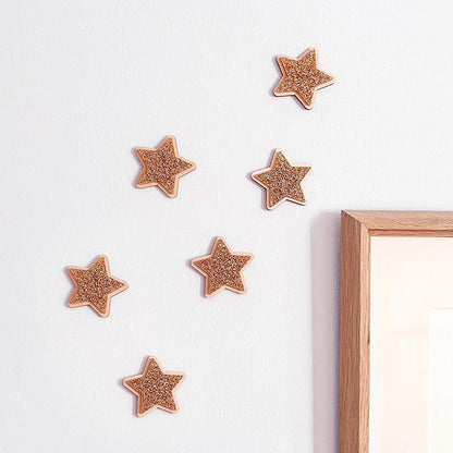 Gold glitter acrylic stars layered onto natural wood for children's wall decor