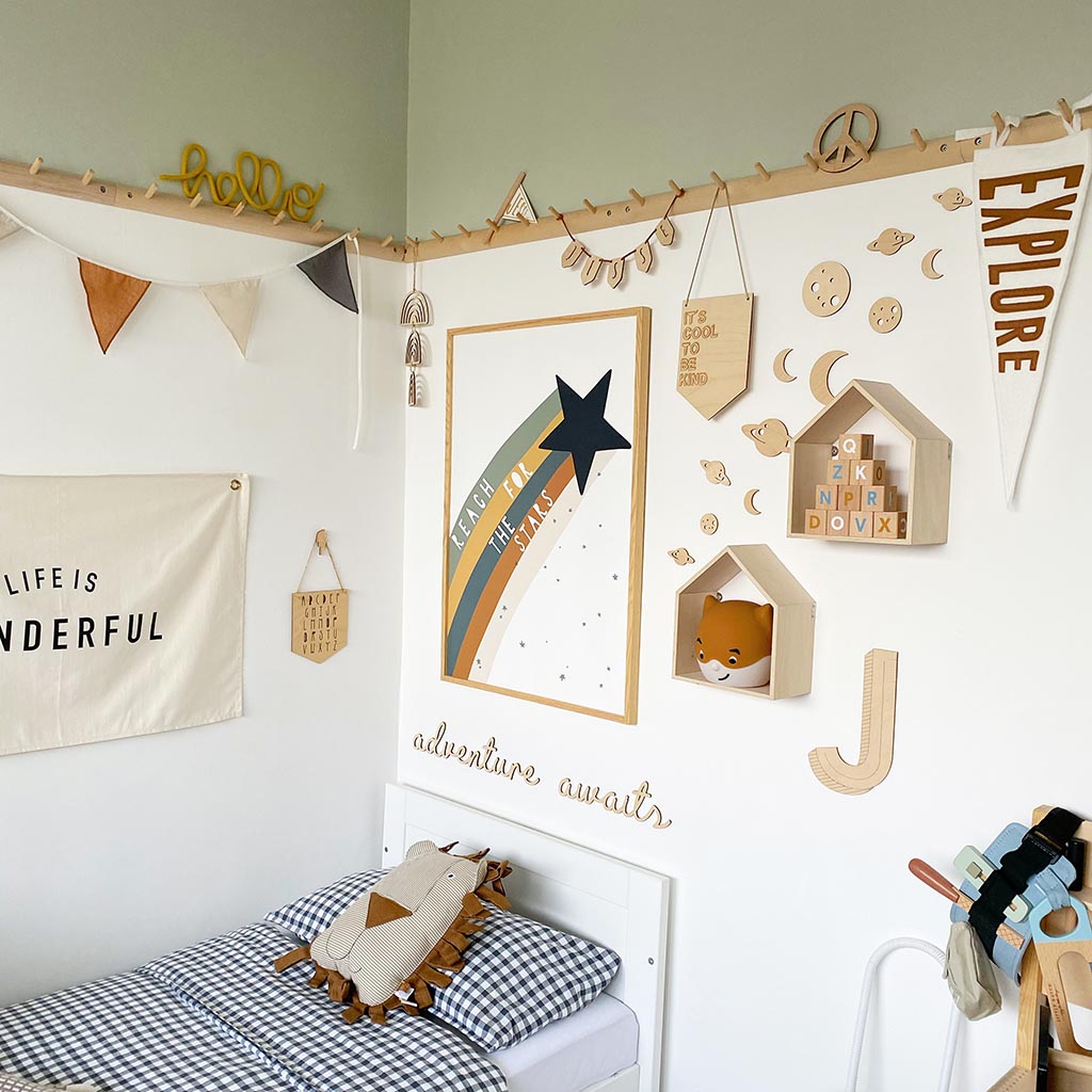 Space themed wooden wall decorations styled in a playful children's bedroom