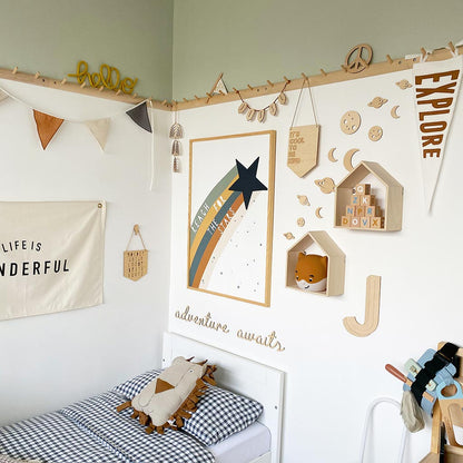 Space themed wooden wall decorations styled in a playful children's bedroom