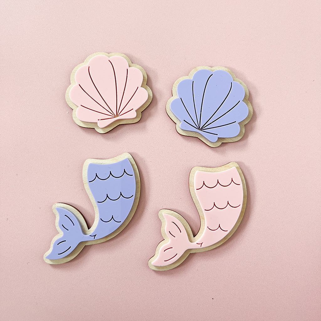 Pink and purple mermaid tails and shell wall decorations for a child's bedroom