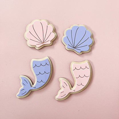 Pink and purple mermaid tails and shell wall decorations for a child's bedroom
