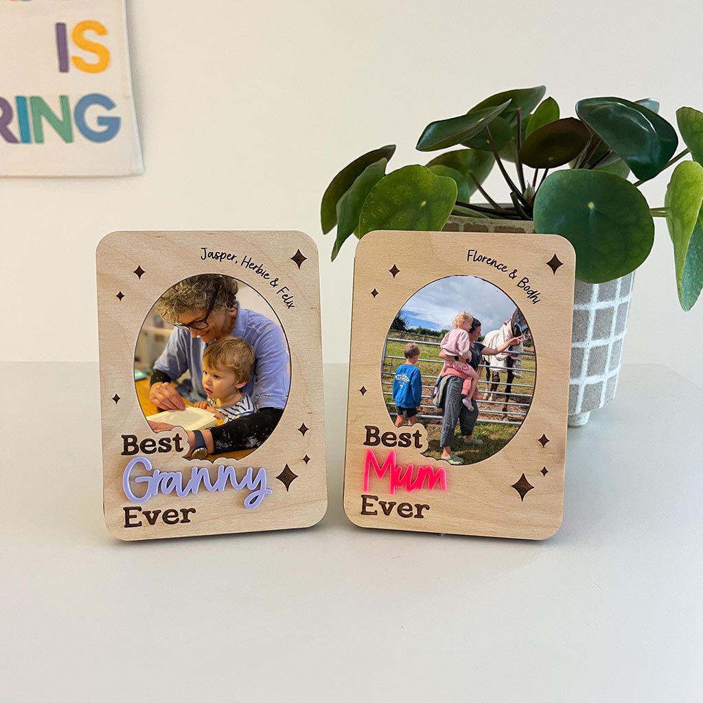 Two wooden photo frames with family photos and text on a light background.