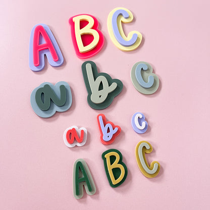 Layered acrylic letter magnets in colourful uppercase and lowercase designs