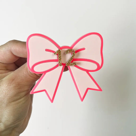 Personalised pink acrylic bow birthday badge with gold glitter number 12