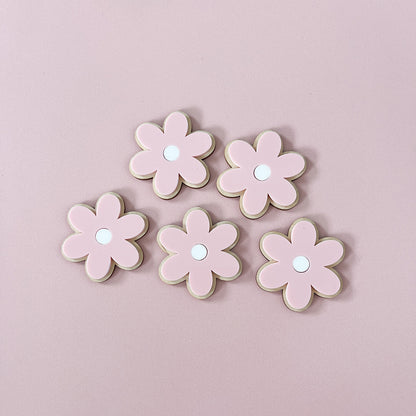 Pink acrylic flowers layered onto natural wood for children's wall decor