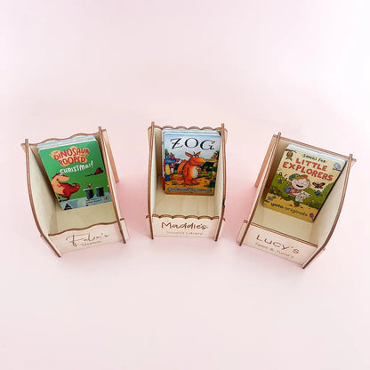 Three personalised wooden Yoto card holders with engraved names and children’s audio cards