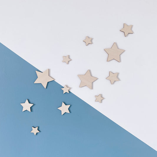 Natural wooden star wall decorations styled in a neutral nursery 